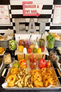 an assortment of food is displayed on a buffet table