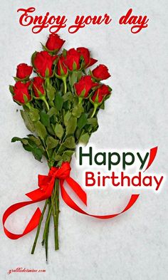 a bunch of red roses sitting on top of a white table next to a ribbon