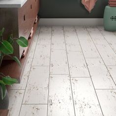 a bathroom with white tile floors and green walls