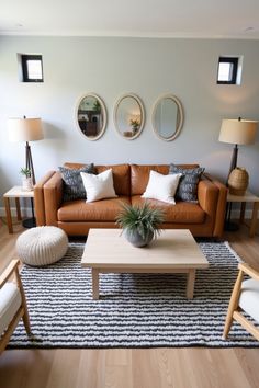 A chic living room featuring a tan leather sofa, modern decor, layered textures, and natural light. Perfect for cozy, contemporary vibes with a touch of minimalism. #ModernLivingRoom #InteriorInspiration #CozyDecor #MinimalistDesign #HomeStyleIdeas Dressing A Tan Leather Sofa, Light Brown Leather Sofa, Tan Leather Sofa Living Room, Leather Sofa Modern, Tan Leather Sofa, Cozy Modern Living Room, Leather Sofa Living, Cozy Contemporary, Tan Leather Sofas