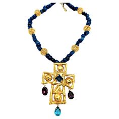 Cross brooch with rhinestone decorations hanging on a blue chain with gold balls by Christian Lacroix Paris, around 1980- Cross brooch without rhinestones is separatly to by for € 750 € Dimensions; Total length cain wieth dross is 35 cm, Length of the blue chain 54 cm, gold plated beads 2 cm in diameter. Lacoix crosss L 9cm x W 7 cm, attached colorful atrss drops 2 cm. Cross an chain both market LACROIX. Very good condition! Christian Lacroix Jewelry, Rhinestone Decorations, Paris Necklace, Cross Brooch, Art Deco Pendant Necklace, Diamond Flower Pendant, Jewelry Cross, Double Necklace, Chanel Necklace