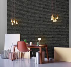 a room with two chairs and a table in front of a brick wall that has lights hanging from it