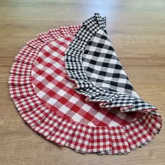 three pieces of cloth sitting on top of a wooden table