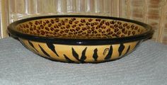 a leopard print bowl sitting on top of a table