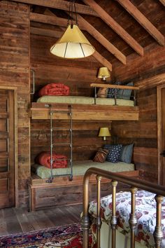 a bedroom with bunk beds and wooden walls