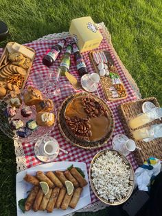 a picnic blanket with food and drinks on it