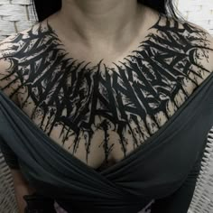 a woman with black ink on her chest