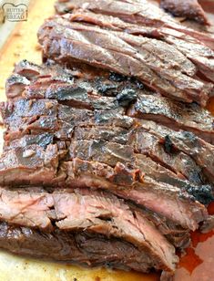 sliced steak on a cutting board with sauce