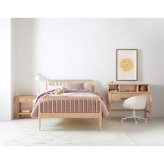 a bedroom with a bed, desk and chair next to a wall mounted art piece