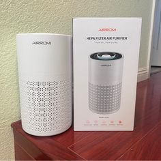 the box is next to an air purifier on top of a table