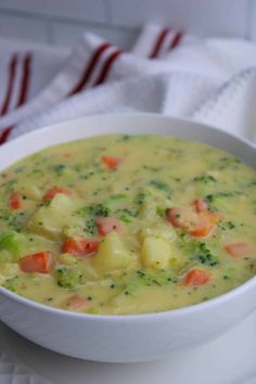 a white bowl filled with broccoli and carrots