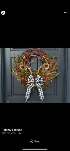 the front door is decorated with an antlers wreath and bow tie, which reads tommy eckhund