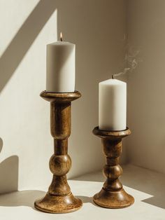 two candles sitting next to each other on a table