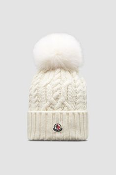 a white hat with a pom - pom on top