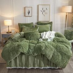 a bed with green comforters and pillows