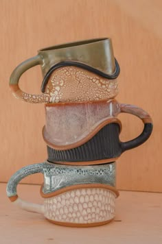 a stack of coffee mugs sitting on top of each other