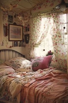 a bedroom with floral curtains and pink bedding