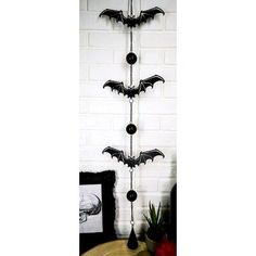 a metal bat decoration hanging from the side of a wall