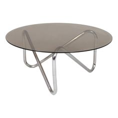 a round glass table with metal legs