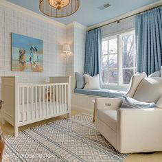 a baby's room with blue and white decor