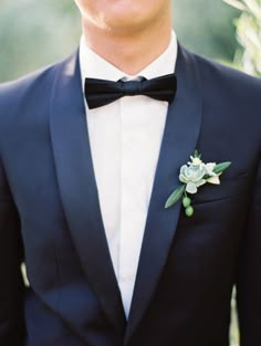 a man in a tuxedo with a boutonniere on his lapel