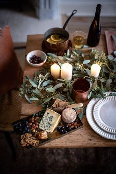 a table topped with lots of food and candles