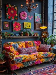 a living room filled with lots of colorful furniture and paintings on the wall above it