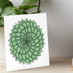 a green flower art print on white paper