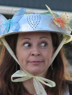 a woman wearing a metal hat with butterflies on it's side and eyes wide open