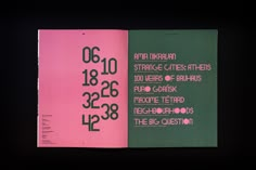 an open book with numbers on it in black and pink cover, against a dark background