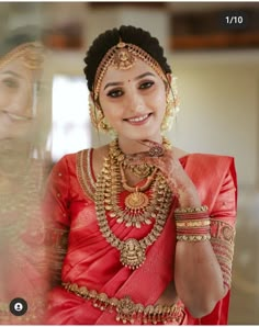 a woman in red and gold is posing for the camera