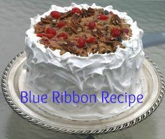 a blue ribbon recipe cake on a silver platter