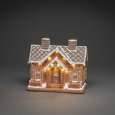 a gingerbread house with lights on it