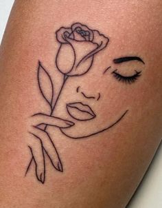 a woman's face with a rose tattoo on her thigh