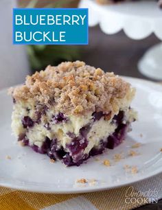 a close up of a piece of cake on a plate with crumb toppings