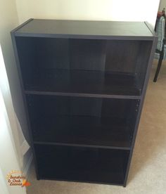 a black bookcase sitting on top of a carpeted floor