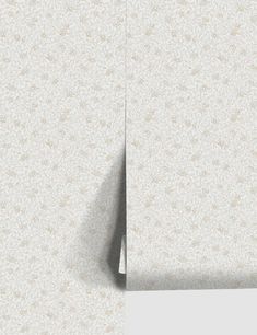 the corner of a white wallpapered room