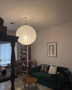 a living room filled with furniture and a lamp hanging over the top of it's head