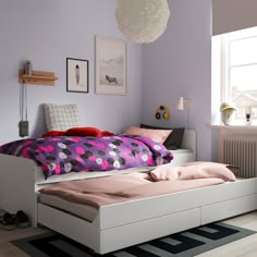 a bedroom with purple walls and white furniture