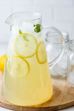 a pitcher filled with lemonade and lime slices