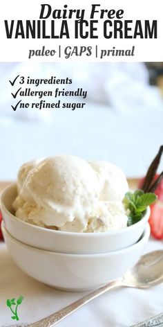 a bowl filled with vanilla ice cream next to strawberries