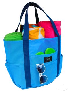 a blue tote bag filled with beach towels and sunglasses