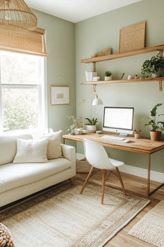 a white couch sitting next to a wooden desk in a living room under a window