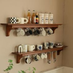 two wooden shelves holding coffee cups and mugs