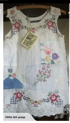 a white shirt with flowers and pictures on it