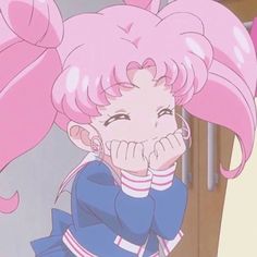 an anime character with pink hair and big ears, holding her hand to her face