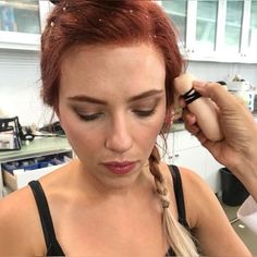 a woman getting her hair done in the kitchen