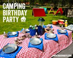 a picnic table set up with plates and bowls for camping birthday party in the park