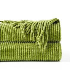 two lime green towels folded on top of each other, one with fringed ends