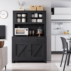 a black hutch with white plates and silverware on it in front of a dining room table